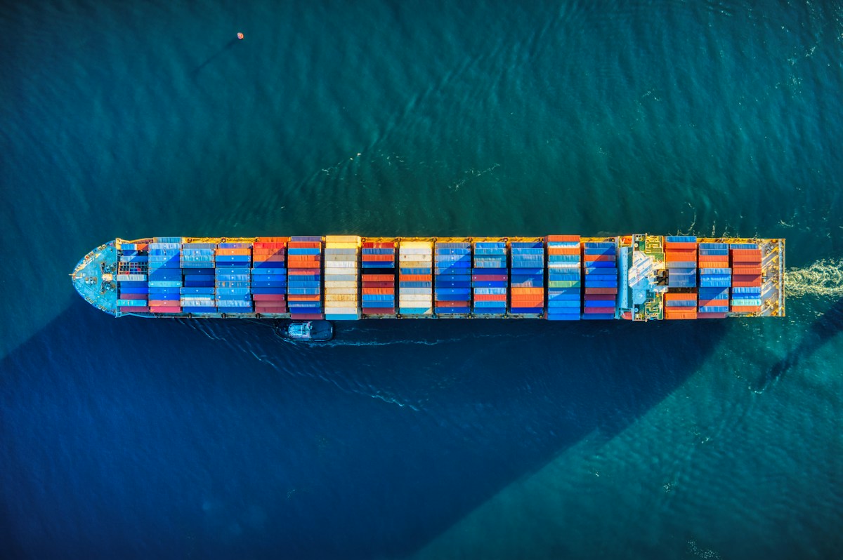 Aerial view of a cargo vessel at sea — Senegal actively enforces restrictions on used tire imports, so confirm current rules before ordering.
