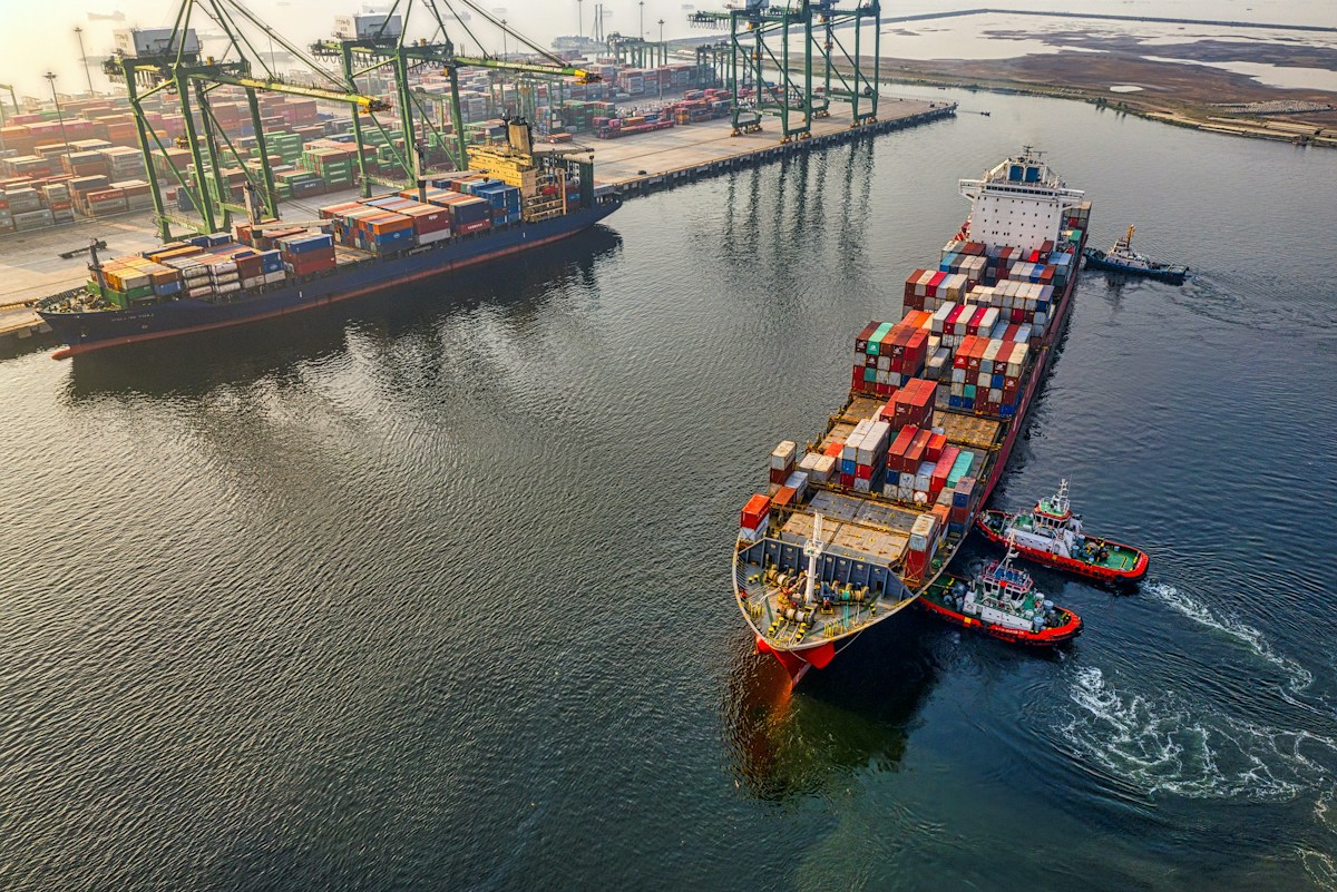 Aerial view of a container ship at sea, representing ocean freight shipments of bulk used tires to the Port of Freetown, Sierra Leone.